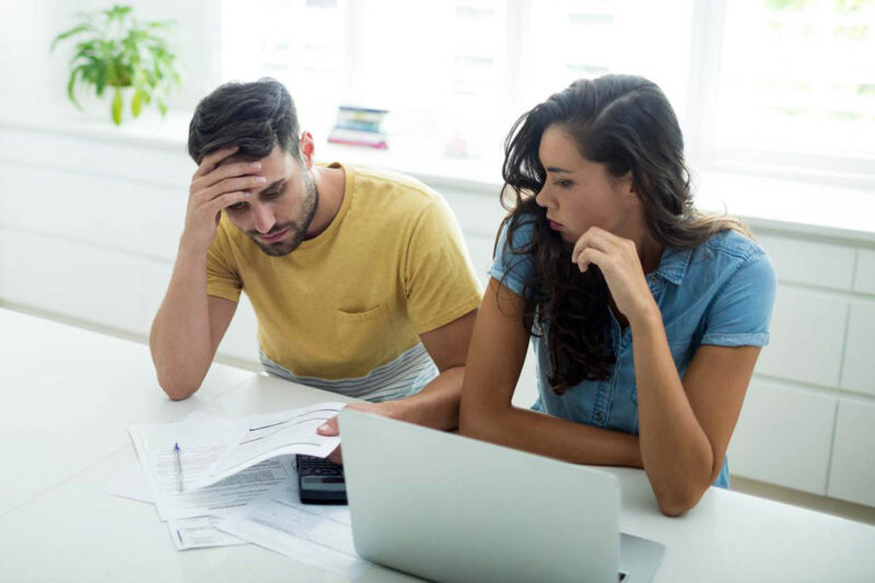 Worried couple calculating their invoices